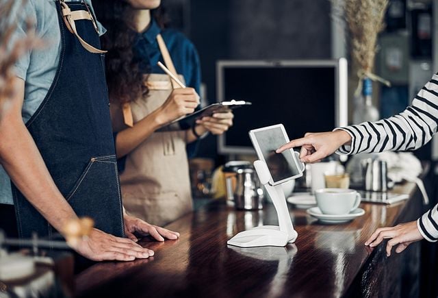 customer self service order drink menu with tablet screen at cafe counter bar