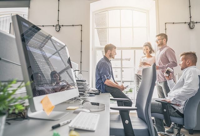 Programmers working in a software development company office.