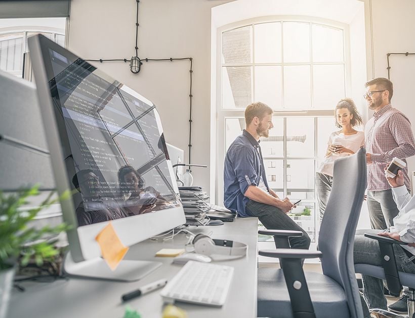 Programmers working in a software development company office.